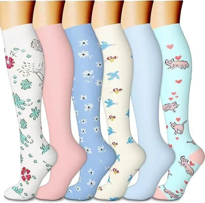 Pairs of long tube compression sports socks in a variety of stylish color combinations