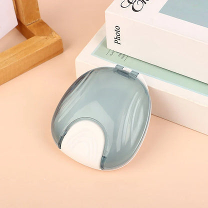 Compact, transparent dental retainer storage box with a push-to-open mechanism for easy access to dental appliances