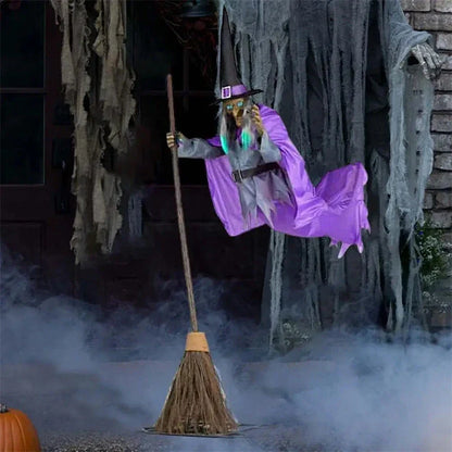 Floating Halloween witch decoration with broom, lifelike facial features, and flowing purple skirt for spooky outdoor display