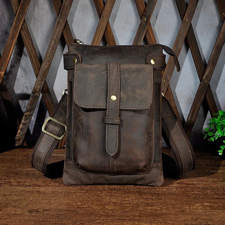 A premium cowhide leather shoulder bag with a compact and versatile design, suitable for various occasions and outdoor activities.