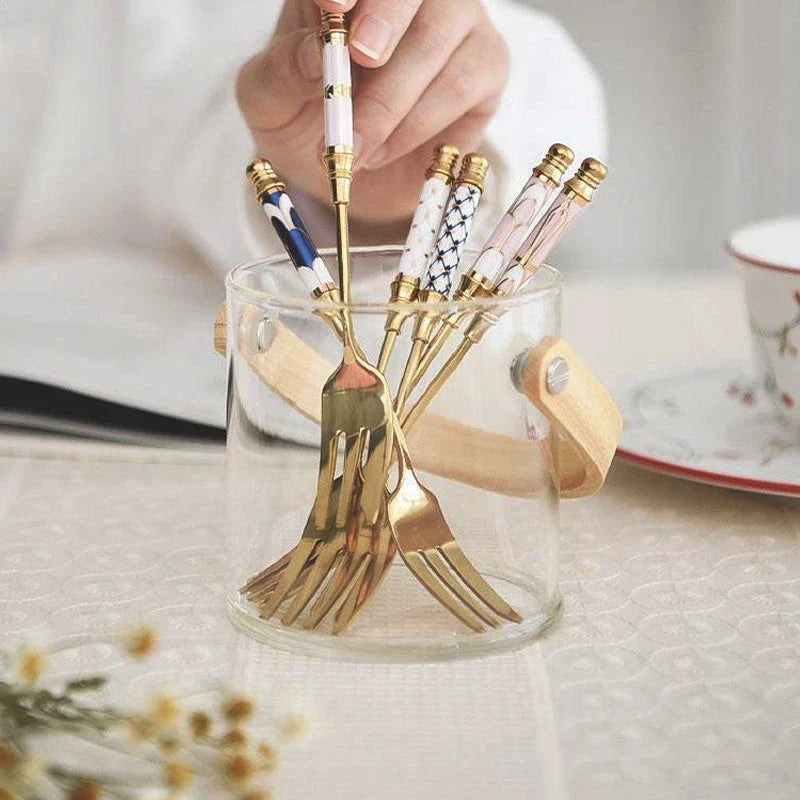 Elegant gold-plated dessert fork with intricate ceramic handle design