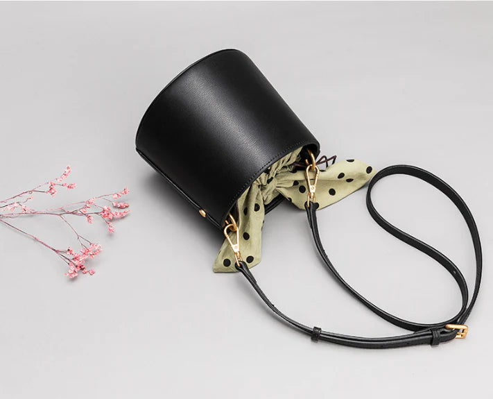 Premium leather bucket bag tote with bow-type closure, exquisite golden hardware, and versatile design