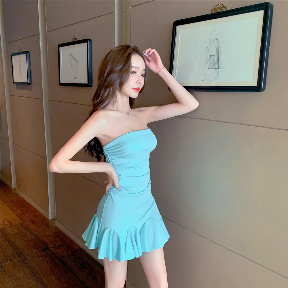 Off-the-shoulder tube top dress with ruffled hip wrap, available in black and lake blue colors