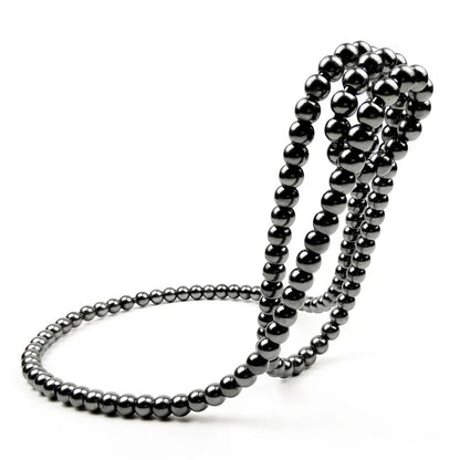 Elegant white iron wine rack with pearl necklace-inspired design, displayed on a desktop or shelf