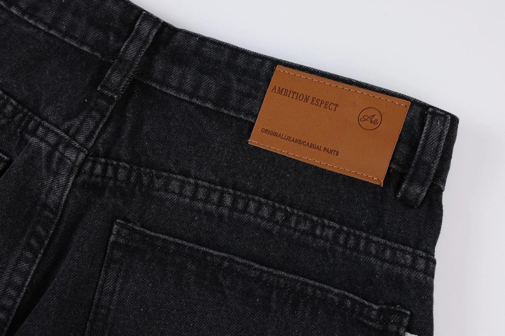 Premium loose fit distressed denim trousers for men and women, featuring a relaxed silhouette, high-quality cotton construction, and trendy distressed details.