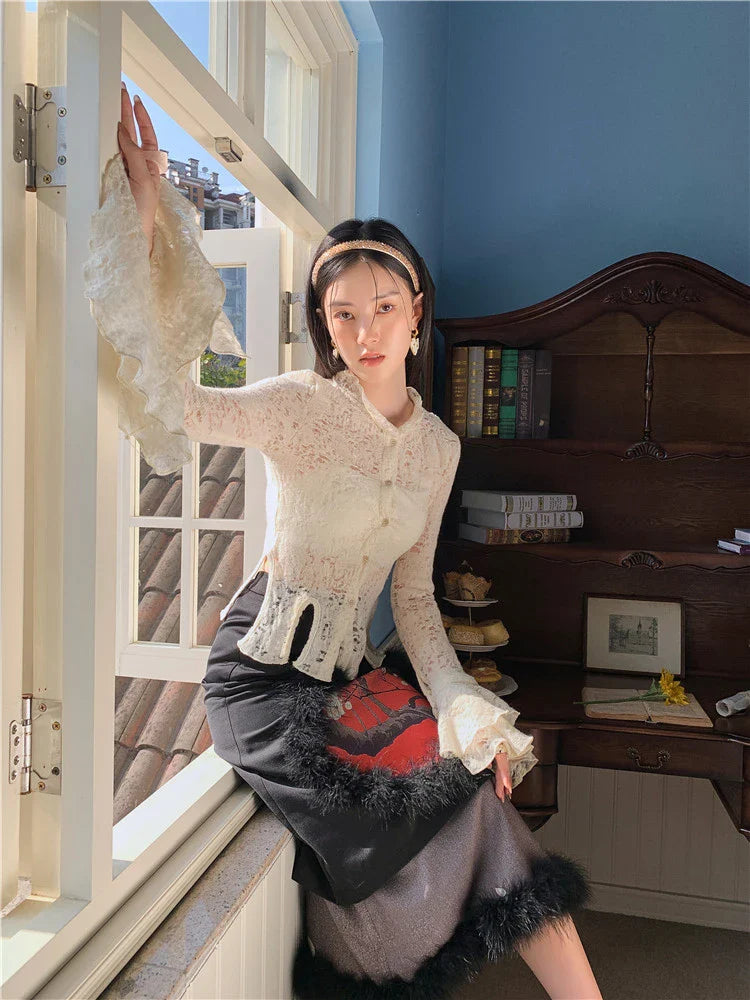 Elegant lace patchwork blouse with ruffled long sleeves and a button-down front in a classic off-white and black color palette.