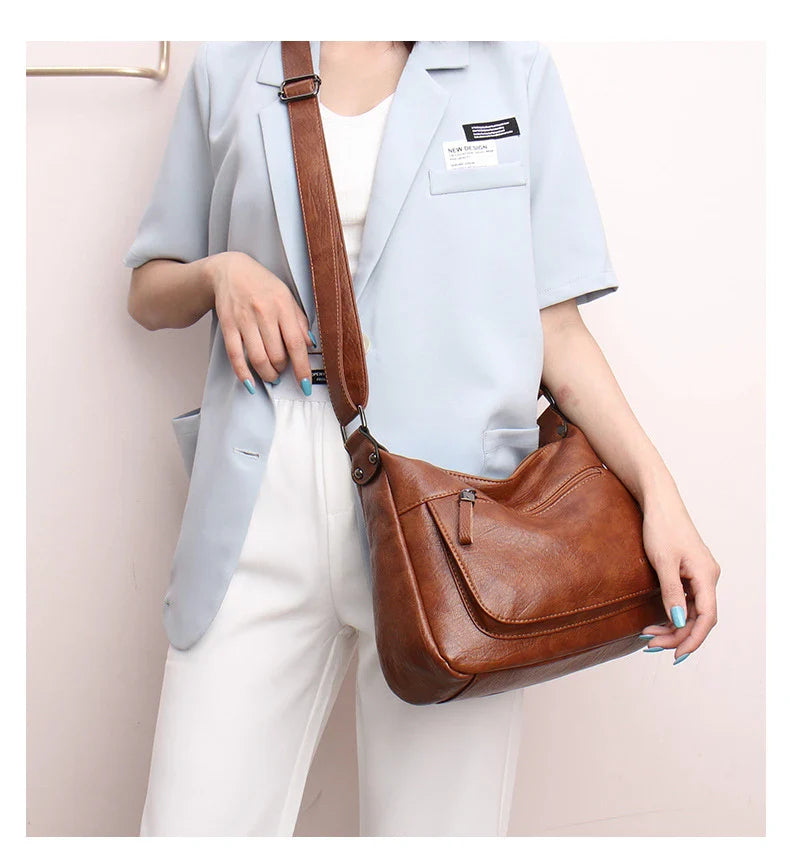 Stylish one-shoulder messenger bag in various colors with a soft, supple PU leather exterior and a spacious, organized main compartment