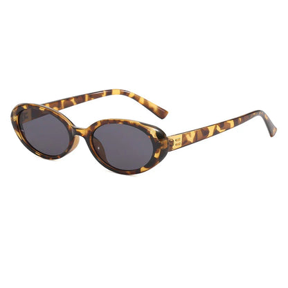 Chic oval sunglasses with white grey acetate frames and polycarbonate lenses, designed for fashionable women to shield their eyes from UV rays in style.