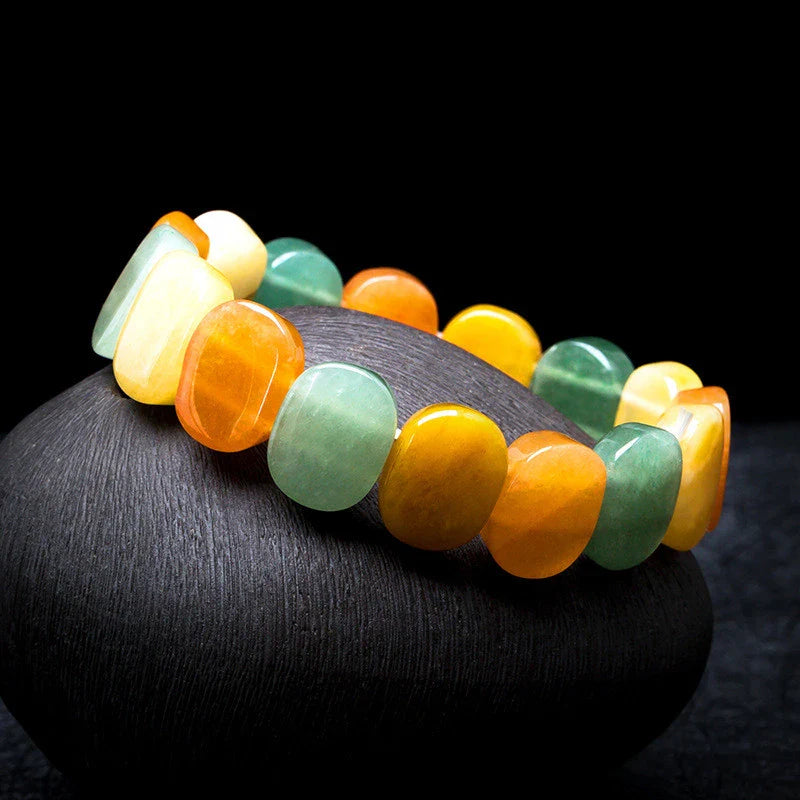 Closeup of a natural tiger eye crystal bracelet with a geometric design, showcasing its unique and calming beauty.