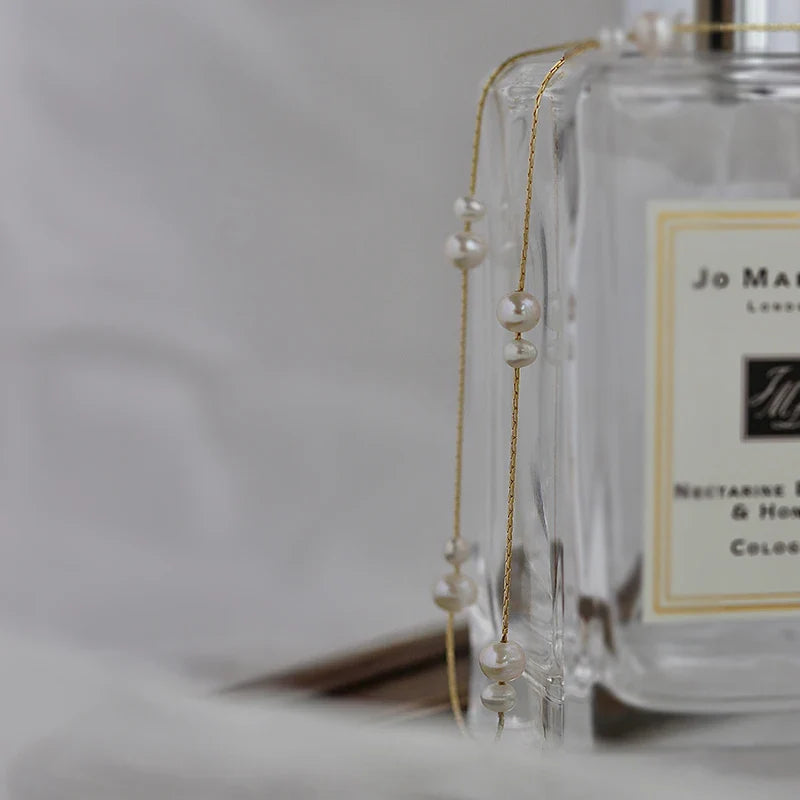 Elegant mother-of-pearl necklace with delicate butterfly and dragonfly motifs, inspired by Asian design