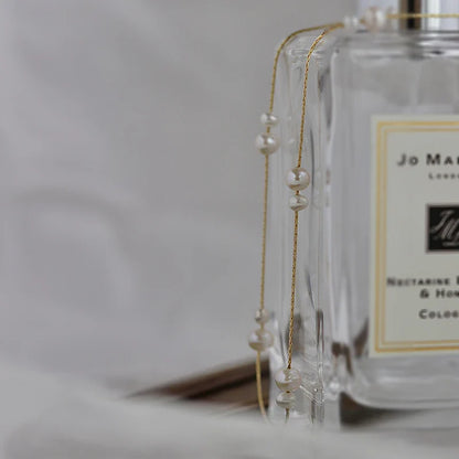 Elegant mother-of-pearl necklace with delicate butterfly and dragonfly motifs, inspired by Asian design