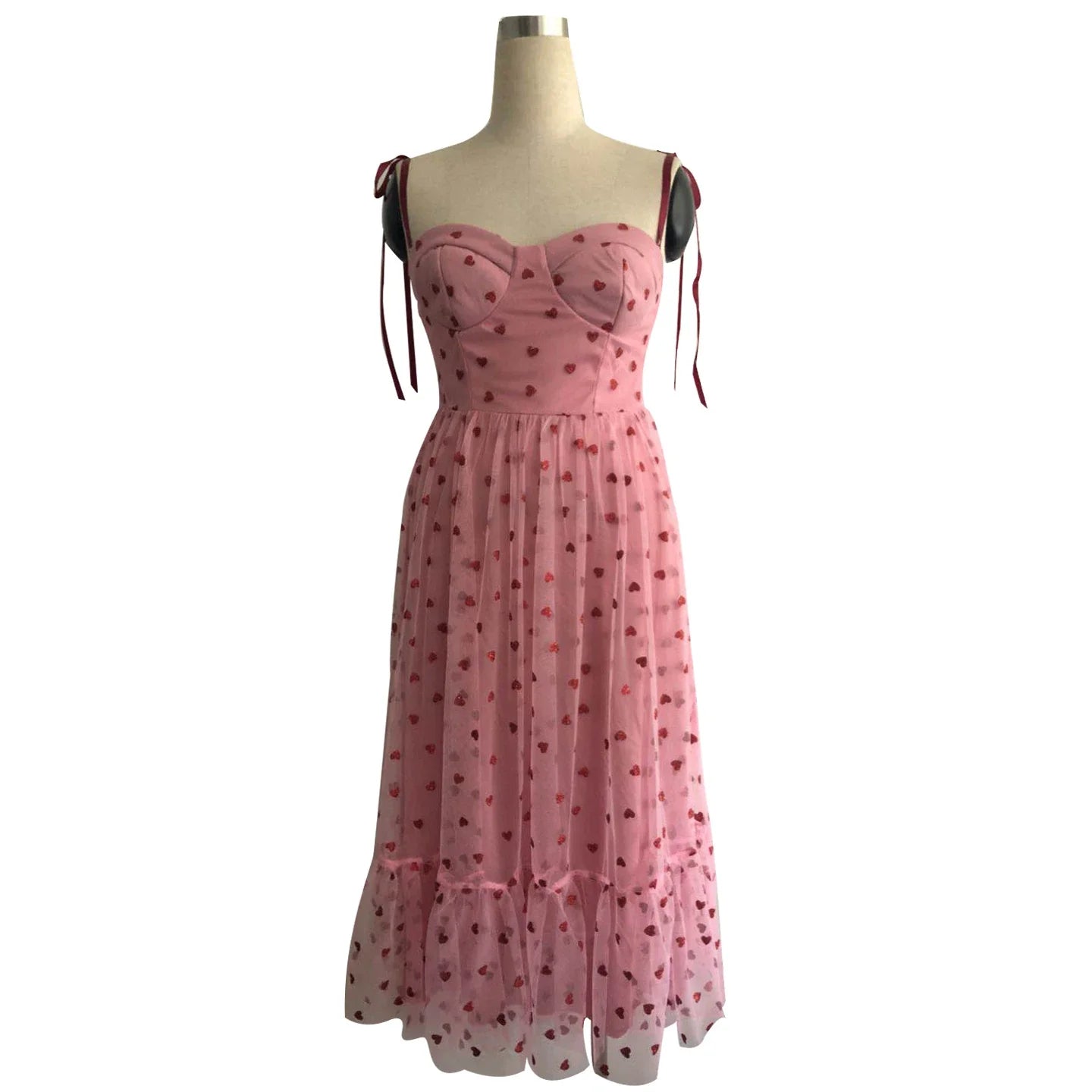 A stylish polka dot dress with a bandeau waist and flared skirt, perfect for elegant occasions or everyday wear.