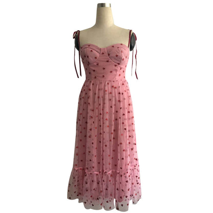 A stylish polka dot dress with a bandeau waist and flared skirt, perfect for elegant occasions or everyday wear.