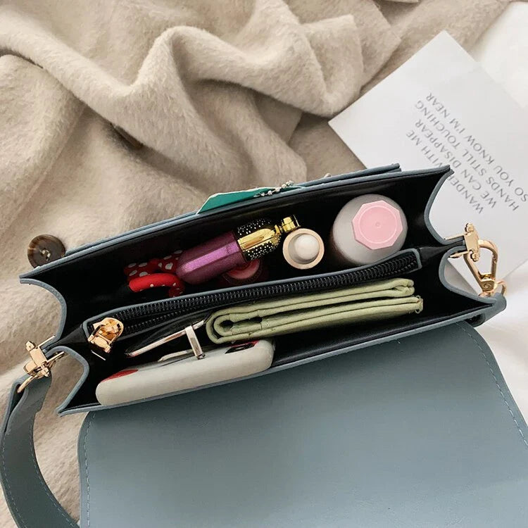 Stylish black crossbody shoulder bag with adjustable strap and multiple interior compartments for modern women