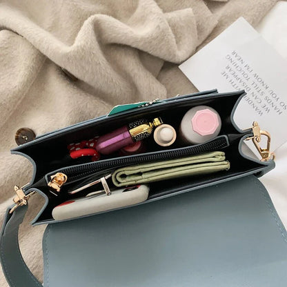 Stylish black crossbody shoulder bag with adjustable strap and multiple interior compartments for modern women