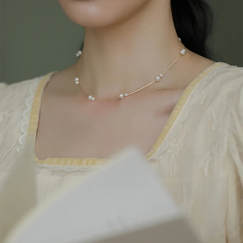 Elegant mother-of-pearl necklace with delicate butterfly and dragonfly motifs, inspired by Asian design