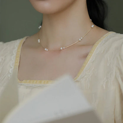 Elegant mother-of-pearl necklace with delicate butterfly and dragonfly motifs, inspired by Asian design