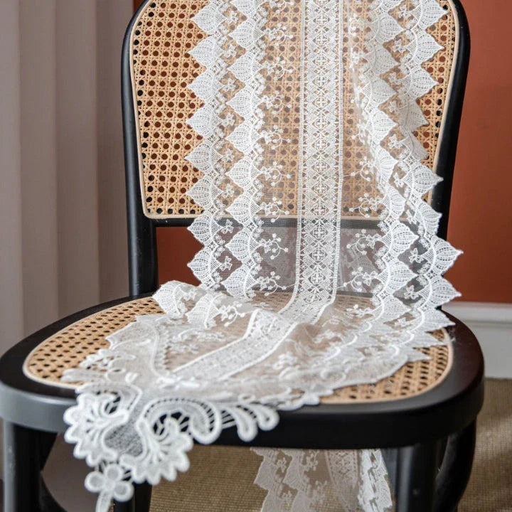 Elegant and refined lace table runner with intricate embroidery and hollowed-out patterns, perfect for sophisticated dining experiences