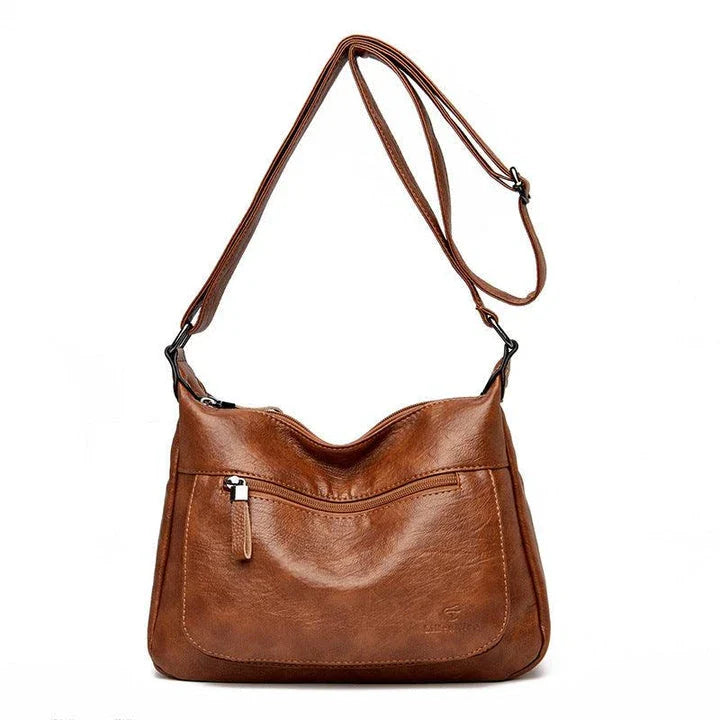 Stylish one-shoulder messenger bag in various colors with a soft, supple PU leather exterior and a spacious, organized main compartment