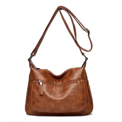 Stylish one-shoulder messenger bag in various colors with a soft, supple PU leather exterior and a spacious, organized main compartment