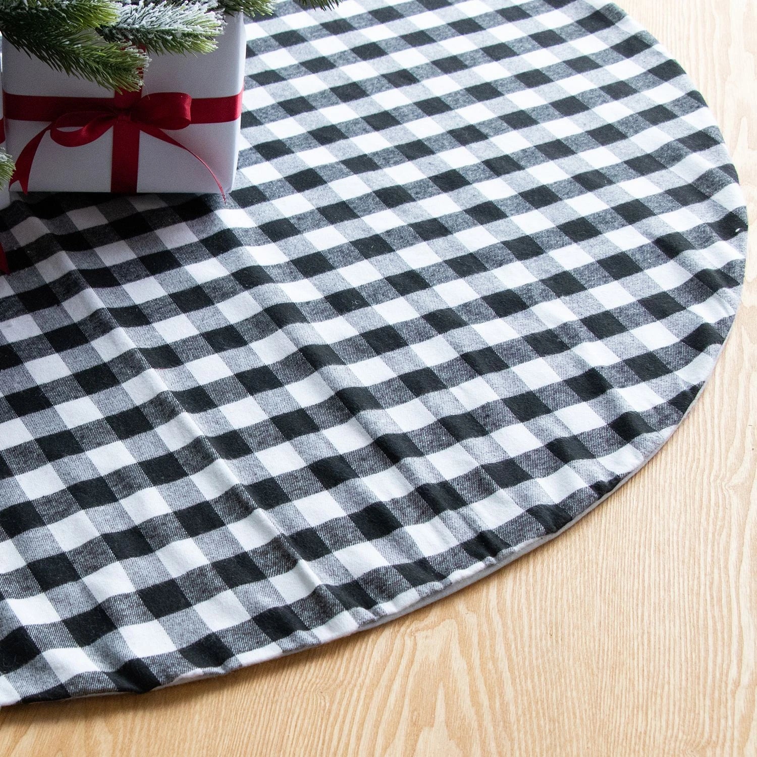 Premium black and white plaid Christmas tree skirt with classic pattern and durable non-woven fabric construction
