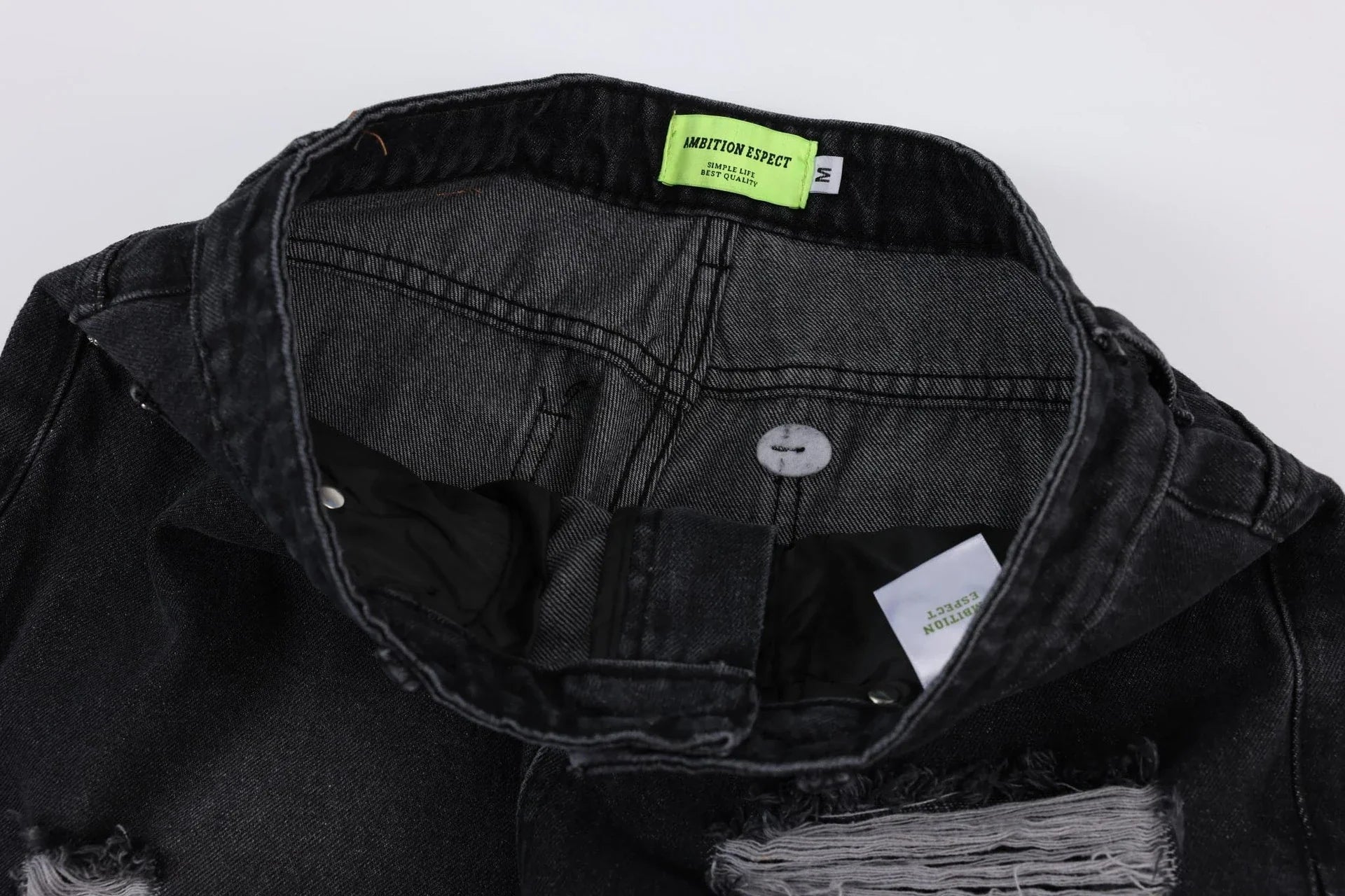 Premium loose fit distressed denim trousers for men and women, featuring a relaxed silhouette, high-quality cotton construction, and trendy distressed details.