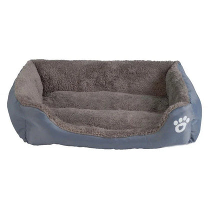 A plush, green pet bed with a paw-print pattern, designed to provide cozy and waterproof comfort for pets.