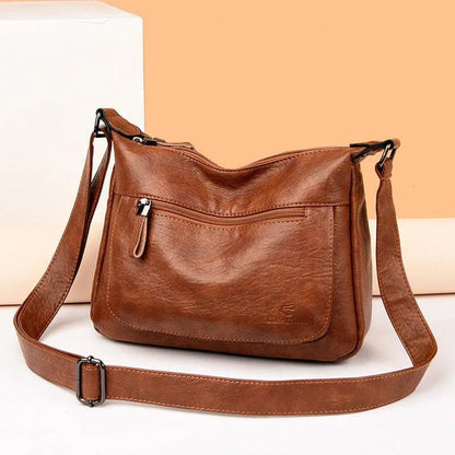 Stylish one-shoulder messenger bag in various colors with a soft, supple PU leather exterior and a spacious, organized main compartment