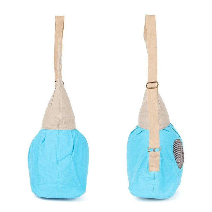 Breathable canvas crossbody carrier for pets with adjustable strap and roomy interior