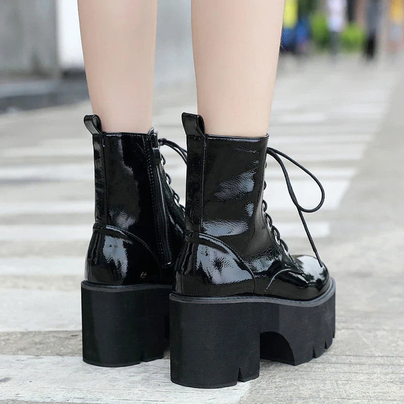 A pair of stylish lace-up high heel boots in black, featuring a sleek design and microfiber interior for comfort.
