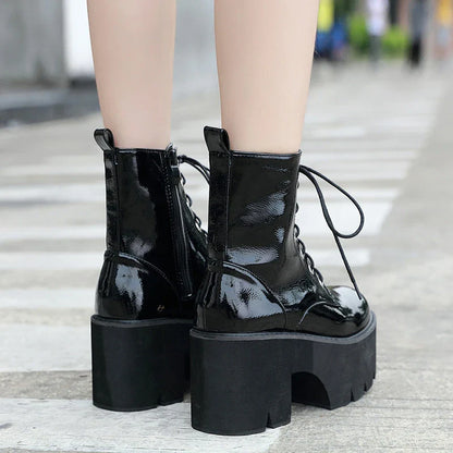 A pair of stylish lace-up high heel boots in black, featuring a sleek design and microfiber interior for comfort.
