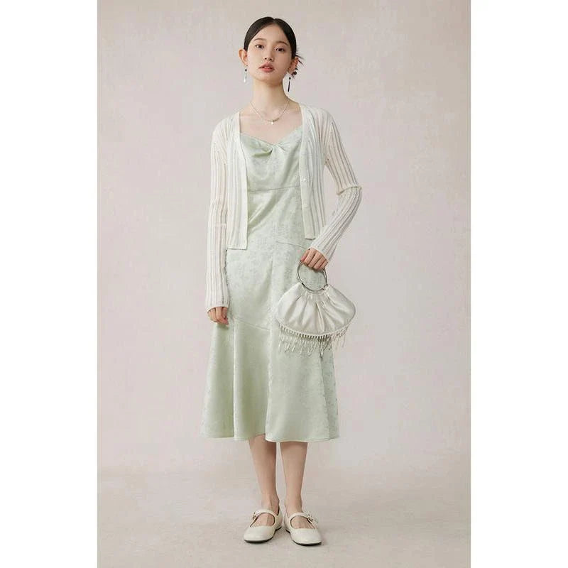 Elegant mint green midi dress with spaghetti straps, featuring a slim fit and intricate embroidery details