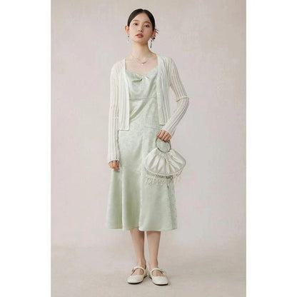 Elegant mint green midi dress with spaghetti straps, featuring a slim fit and intricate embroidery details