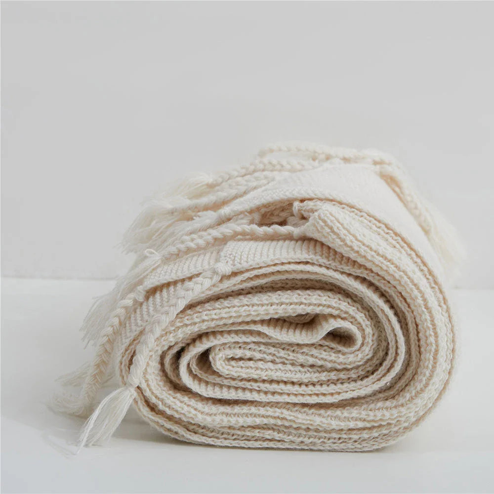 Luxurious Nordic wool knitted throw blanket with tassels in a solid gray color, a cozy and elegant home decor accessory