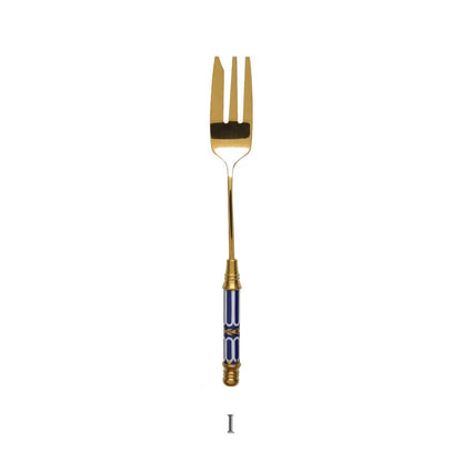 Elegant gold-plated dessert fork with intricate ceramic handle design