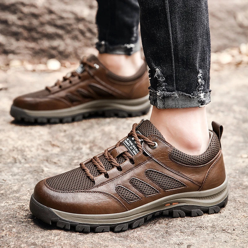 Breathable casual leather sports shoes for men in black and brown colors, featuring a mesh upper and flexible plastic sole for all-day comfort and style.