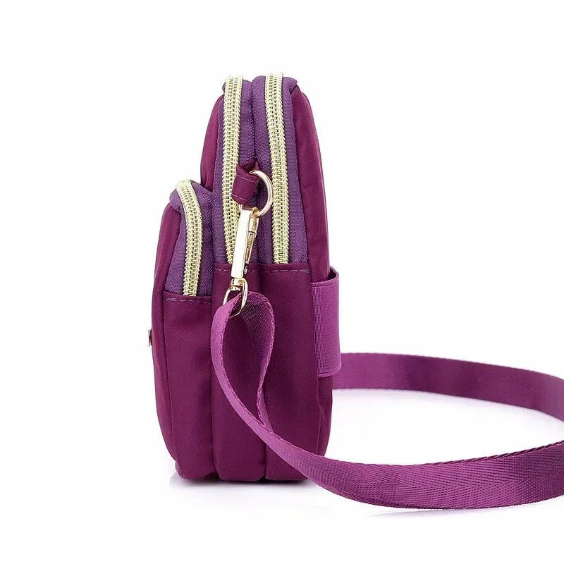 Fashionable women's crossbody phone bag with multi-function pockets, headphone plug, and stylish decorations