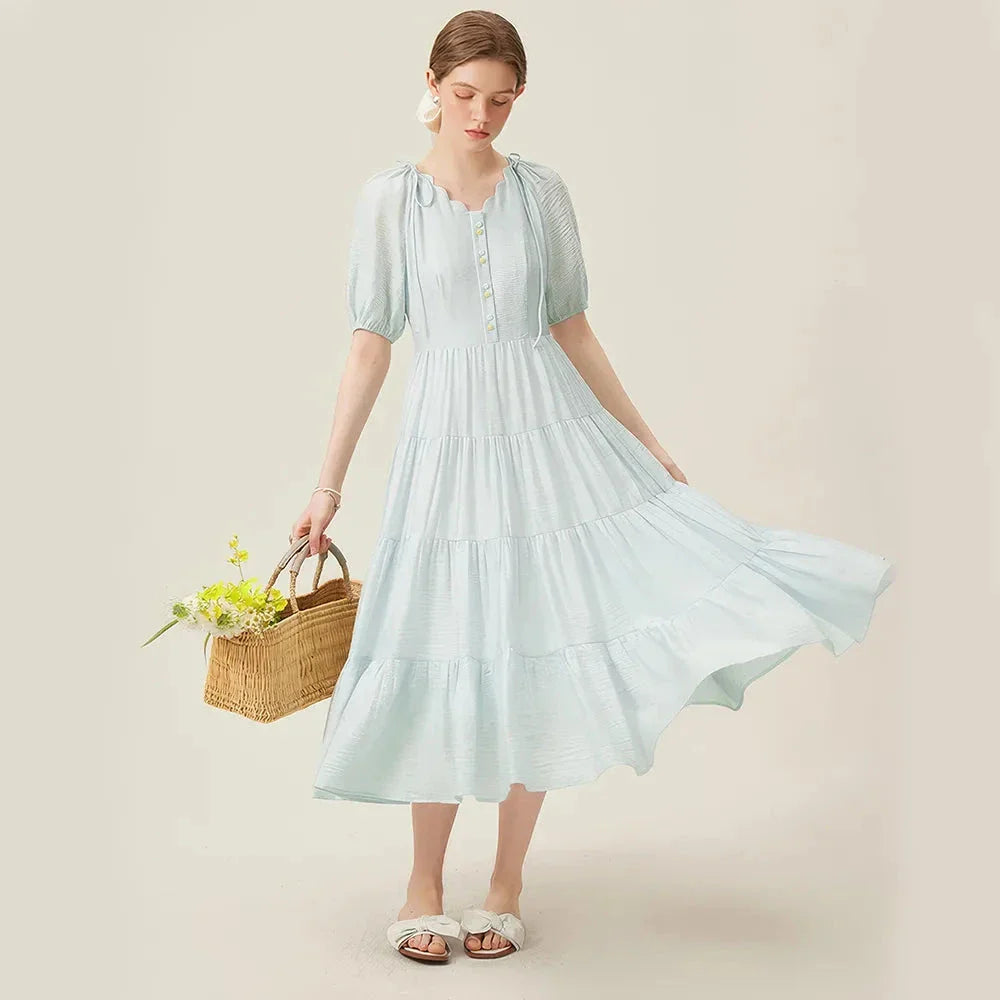 A chic, French-inspired summer dress with an empire waistline, V-neck, and A-line silhouette, perfect for seaside elegance.