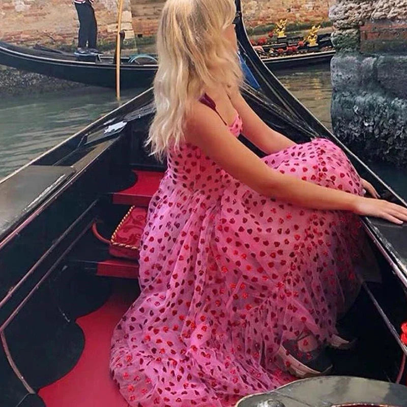 A stylish polka dot dress with a bandeau waist and flared skirt, perfect for elegant occasions or everyday wear.