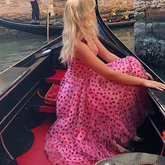 A stylish polka dot dress with a bandeau waist and flared skirt, perfect for elegant occasions or everyday wear.