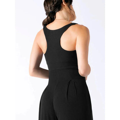 Chic sleeveless jumpsuit with wide-leg pants, made with Rayon and Spandex for comfort and breathability.
