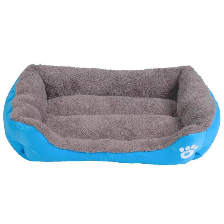 A plush, green pet bed with a paw-print pattern, designed to provide cozy and waterproof comfort for pets.