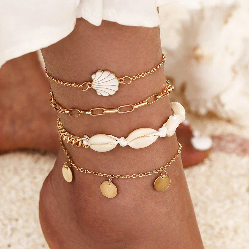 A pair of boho-inspired anklets adorned with natural shells and crushed stones, showcasing a unique geometric design for effortless summer style.