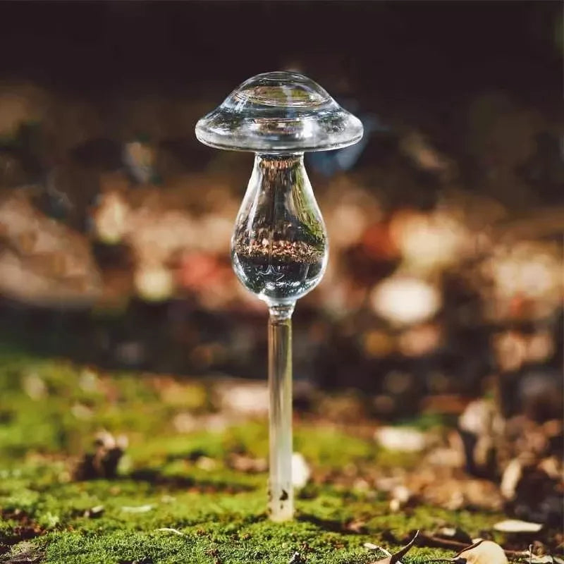 Automatic self-watering plant device in decorative designs including birds, stars, and mushrooms