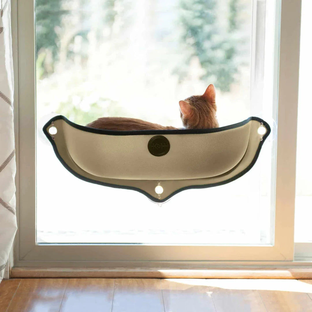 Cozy beige felt cat window hammock bed with plush mat, attached to window with suction cups