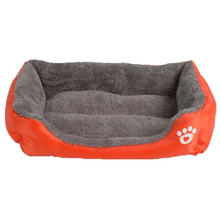 A plush, green pet bed with a paw-print pattern, designed to provide cozy and waterproof comfort for pets.