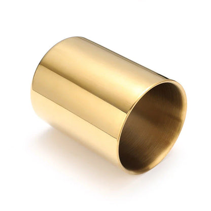 Elegant gold stainless steel desk organizer holding pens, pencils, and makeup brushes on a modern workspace