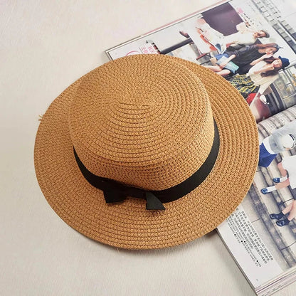 Classic straw Panama hat with a bow detail, offering sun protection and fashionable summer style