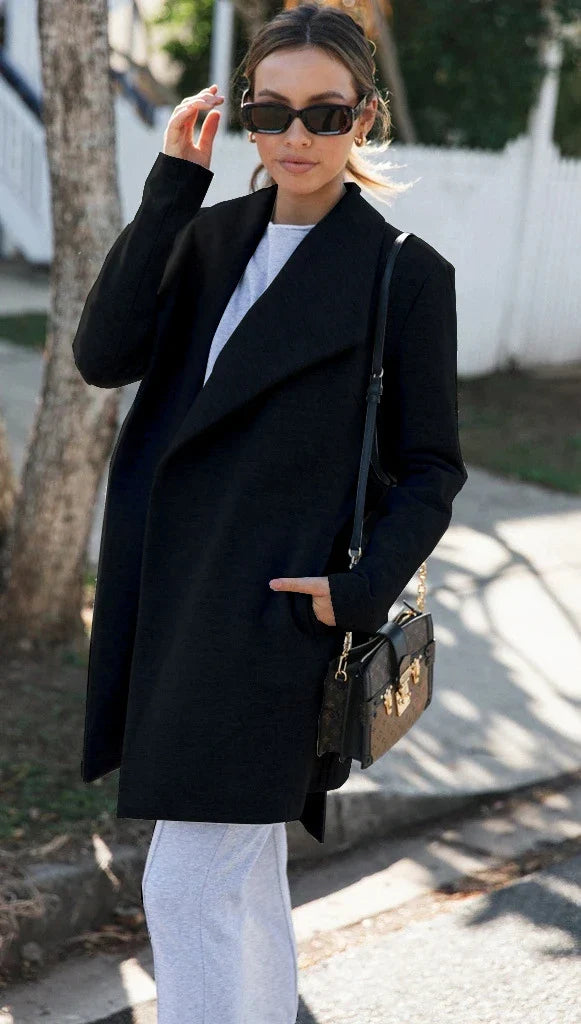 A versatile polyester trench coat in grey, featuring a classic silhouette and convenient design for easy layering over any outfit.