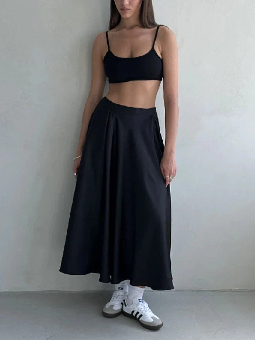 Elegant high-waisted satin maxi skirt in black for women, showcasing a flowing, sophisticated silhouette.